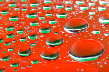The Abstract orange red background with gradient color water drops on glass with reflection, big...