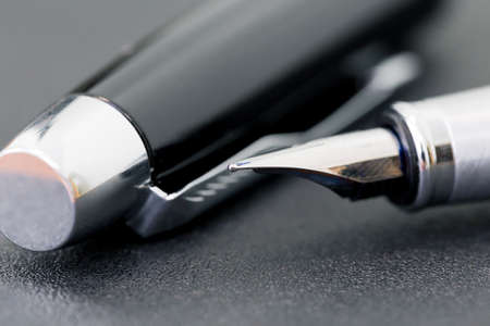 The black pen with a cap on a black background, business conceptの写真素材
