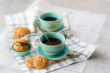 Homemade Cookies with a green cup of coffee. Placed on a white plaid apron.