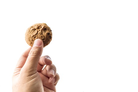 Asian Hand Holding a homemade cookie on white background or isolatedの写真素材