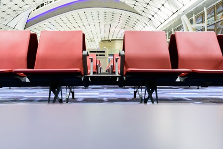 Close up of empty seats for people in the departure area in airport terminalの写真素材