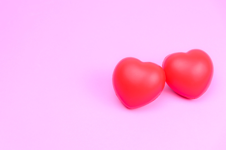 The concept of love For Valentine's Day with two red heart instead of the couples. on pink pastel backgroundの写真素材