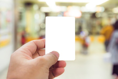Man's hand holding a blank business card.の写真素材