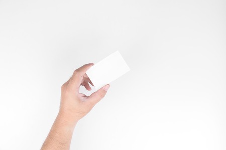 Men's hands are holding the blank business cards on white background or isolatedの写真素材