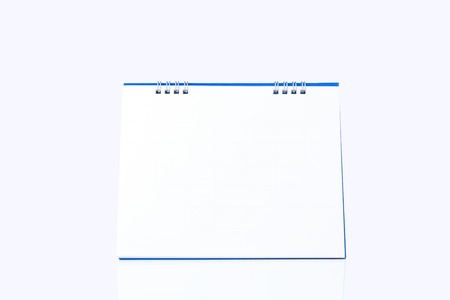 Blank paper desk top or spiral calendar isolated on white backgroundの写真素材