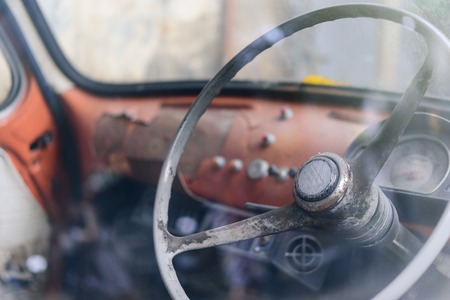 The interior of the older cars were abandoned with the steering wheel.の写真素材