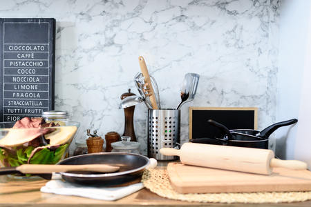Interior of kitchen room with set of kitchenware on marble background.の写真素材