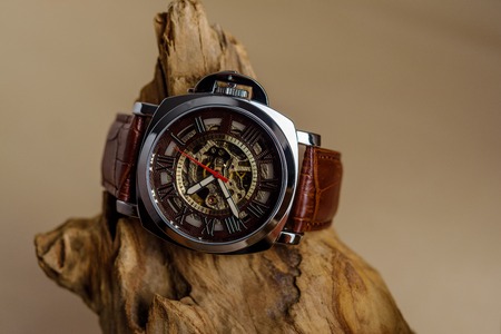 Close up of Luxury man wrist watches placed on timber in brown background