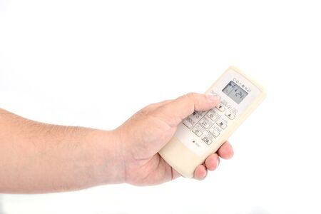Asian's man hand is holding a remote control of air conditioner for open , close or Adjust...