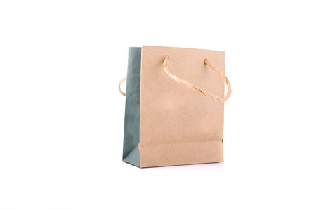 Brown paper shopping bag with handle robe isolated on whiteの写真素材