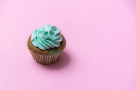 Homemade banana cup cake with mint whip cream isolated on pink pastel backgroundの写真素材