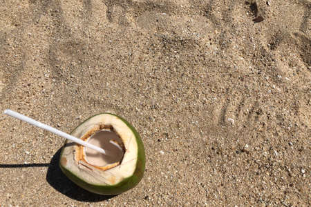 Green coconut on a tropical beach