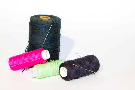 Color sewing threads on white background