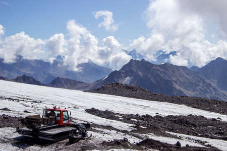 Red ratrak on the snow-covered slope of Elbrus. Ratrak are used to prepare slopes for skiers and for the docking of mountaineersの写真素材