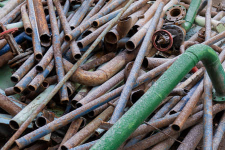 Many colorful old water pipes metal lying on the asphaltの写真素材