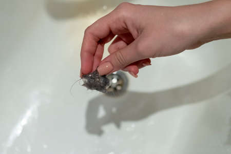 The girl got Hair clump from a bathtub. bath hairの写真素材