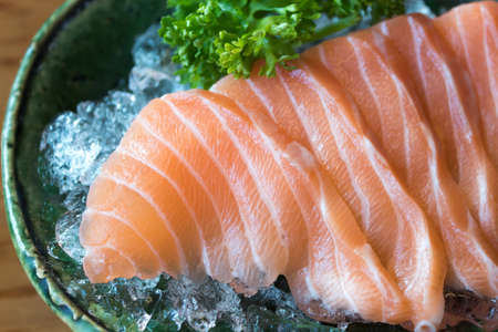 Close up of salmon, sashimi, japanese food on the ice bowlの写真素材