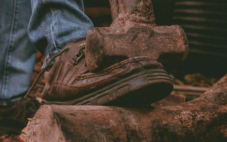 Up-close photo taken of wranglers boots during a hike in the rural hilly parts of Enugu, Nigeriaのeditorial素材