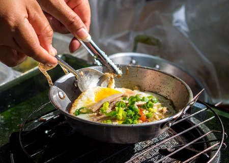 Chef cooking egg frying pan,Thai foods.の写真素材