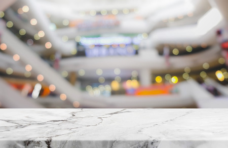 Stone table top on blur with bokeh shopping mall background - can be used for display or montage your productsの写真素材