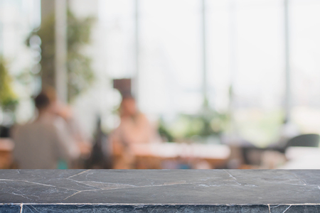 Stone table top and blurred restaurant interior background - can used for display or montage your products.の写真素材