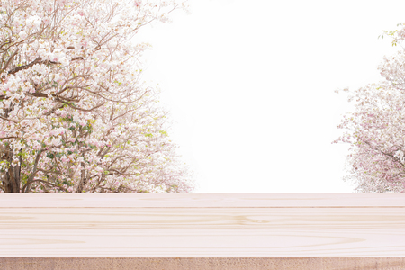 Wood table top and blurred flowers background with vintage filterの写真素材