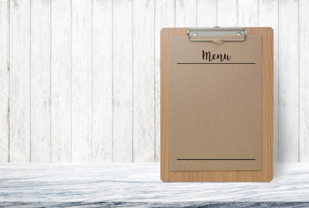 Blank Menu paper notepad on stone table top at grey old wooden wall,Template mock up for adding your design.の写真素材