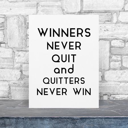 Inspiration Quote on paper at black stone table top at white granite stone wallの写真素材