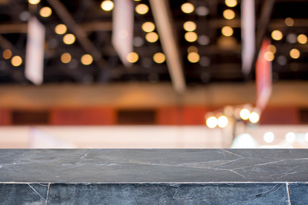 Stone table top on blur with bokeh exhibition hall background - can be used for display or montage your productsの写真素材