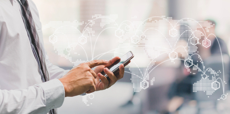 Business man using smart phone on window with futuristic technology connection shape over the...