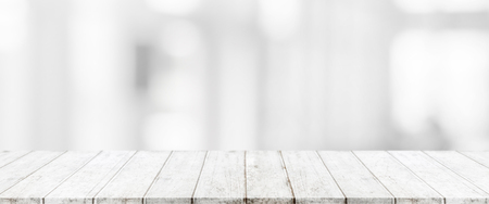 Wood table top and blurred abstract background from interior building banner background - can used for display or montage your products.の写真素材