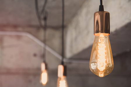 Vintage old lamp in coffee shop cafe interior with concrete wall background.