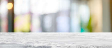 Empty white marble stone table top and blur glass window interior restaurant banner mock up abstract background - can used for display or montage your products.の写真素材