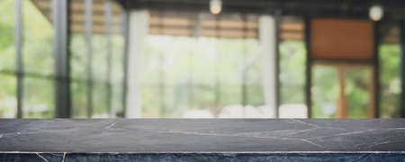 Empty black marble stone table top and blurred coffee shop, cafe and restaurant interior background...