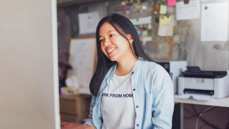Asian young business woman working from home office.New normal lifestyle concept of lockdown,...