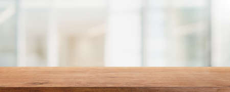 Empty wood table top and blurred coffee shop and restaurant interior background - can used for...