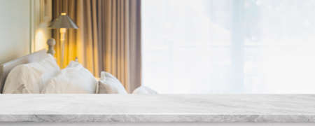 Empty white marble stone table top and blurred living room in home interior with curtain window background. - can used for display or montage your products.の写真素材
