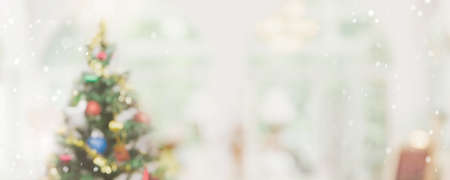 Abstract  blurred bokeh Christmas tree with snowfall  banner background. Christmas and Happy new year concept.の写真素材