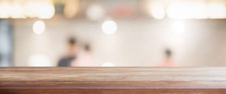Empty wood table top and blur glass window interior restaurant banner mock up abstract background - can used for display or montage your products.の写真素材