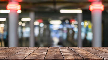 Empty wood table top on abstract blurred restaurant and cafe background - can be used for display or montage your productsの写真素材