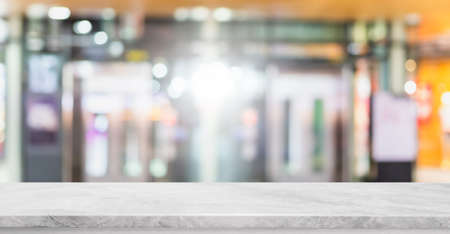 Empty white marble stone table top and blur glass window interior shopping mall banner mock up...
