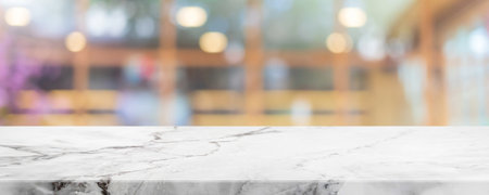 Empty white marble stone table top and blur glass window interior cafe and restaurant banner mock up abstract background - can used for display or montage your products.の写真素材