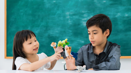Asian happy school girl and boy learning and play with toy model on black board background with copy space.Creative education of kid student concept.の写真素材