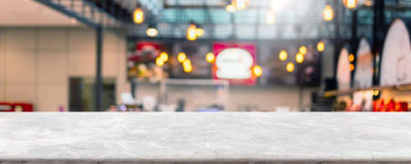Empty white marble stone table top and blur glass window interior cafe and restaurant banner mock up abstract background - can used for display or montage your products.の写真素材