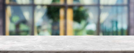 Empty white marble stone table top and blur glass window interior cafe and restaurant banner mock up abstract background - can used for display or montage your products.の写真素材