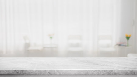 Empty white marble stone table top and blur glass window interior cafe and restaurant banner mock up abstract background - can used for display or montage your products.の写真素材