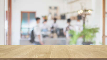 Empty wood table top and blurred coffee shop, cafe and restaurant interior background - can used for...