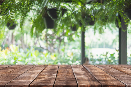 Empty wood table top and blurred green tree and fruit vegetable in agricultural farms background - can used for display or montage your products.の写真素材