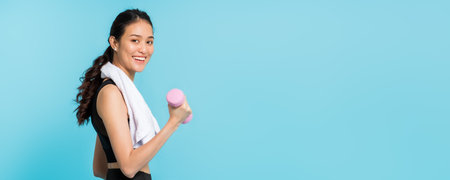 Asian beautiful happy woman stand up and exercise with dumbbell isolated on blue color...