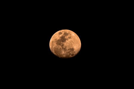 The orange Waxing Gibbous moonの写真素材